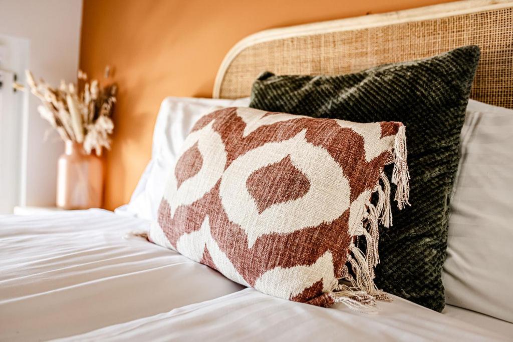 a brown and white pillow sitting on a bed at TinyParks Eiland Tiengemeten in Zuid-Beijerland