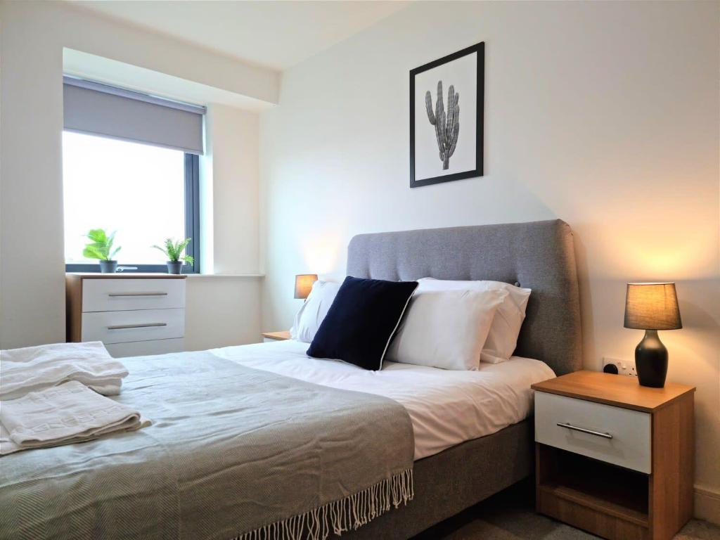 a bedroom with a large bed and a window at Luxury 1 bed apartment 10 mins from Bham City Centre in Birmingham