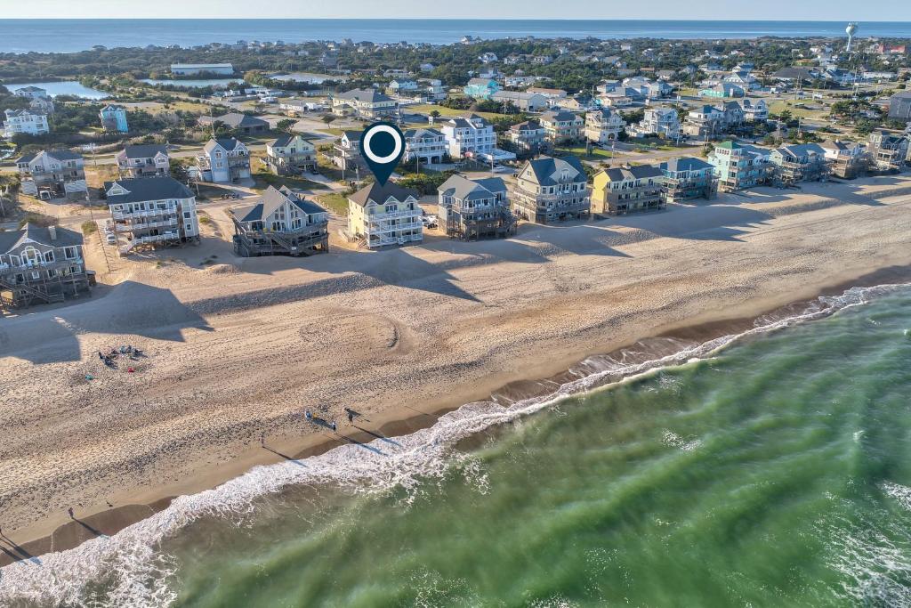 an aerial view of a beach with a blue circle in the middle at Coastal Charm 220 in Avon