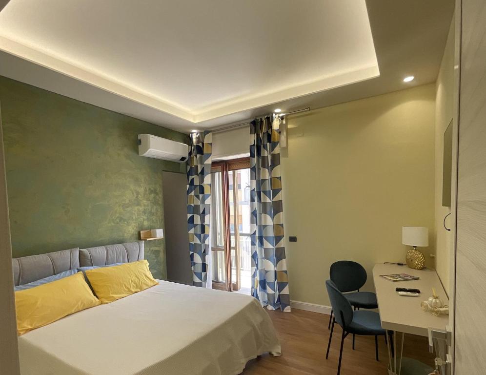 1 dormitorio con cama, mesa y escritorio en Frida, en San Giorgio a Cremano