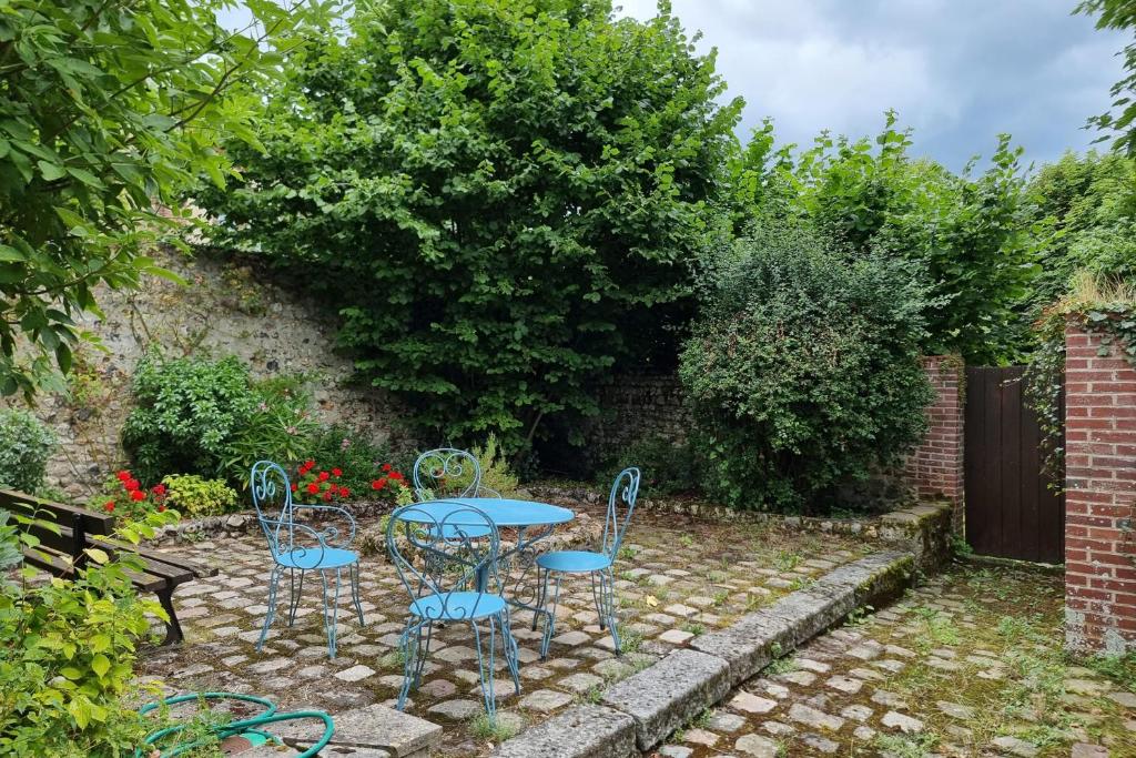 d'une terrasse avec une table et des chaises dans le jardin. dans l'établissement The Saint Jean Suite - Cozy for 2 - Center Honfleur with fireplace, à Honfleur