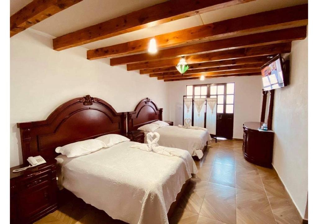 Postel nebo postele na pokoji v ubytování Hotel Hacienda Real