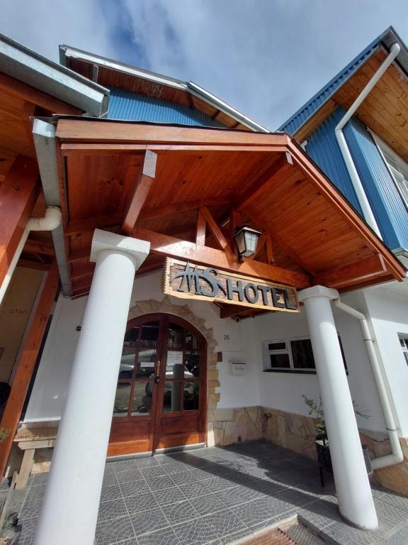 a hotel with a sign on the front of a building at MS Hotel Campos 26 in Ushuaia