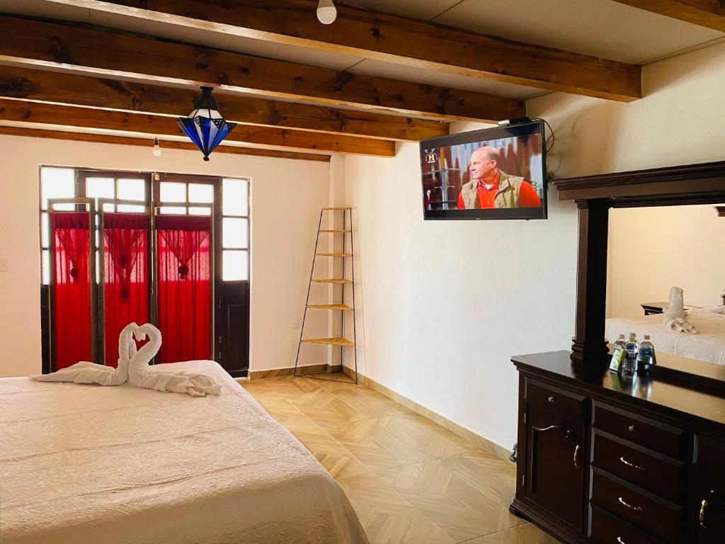 Postel nebo postele na pokoji v ubytování Hotel Hacienda Real