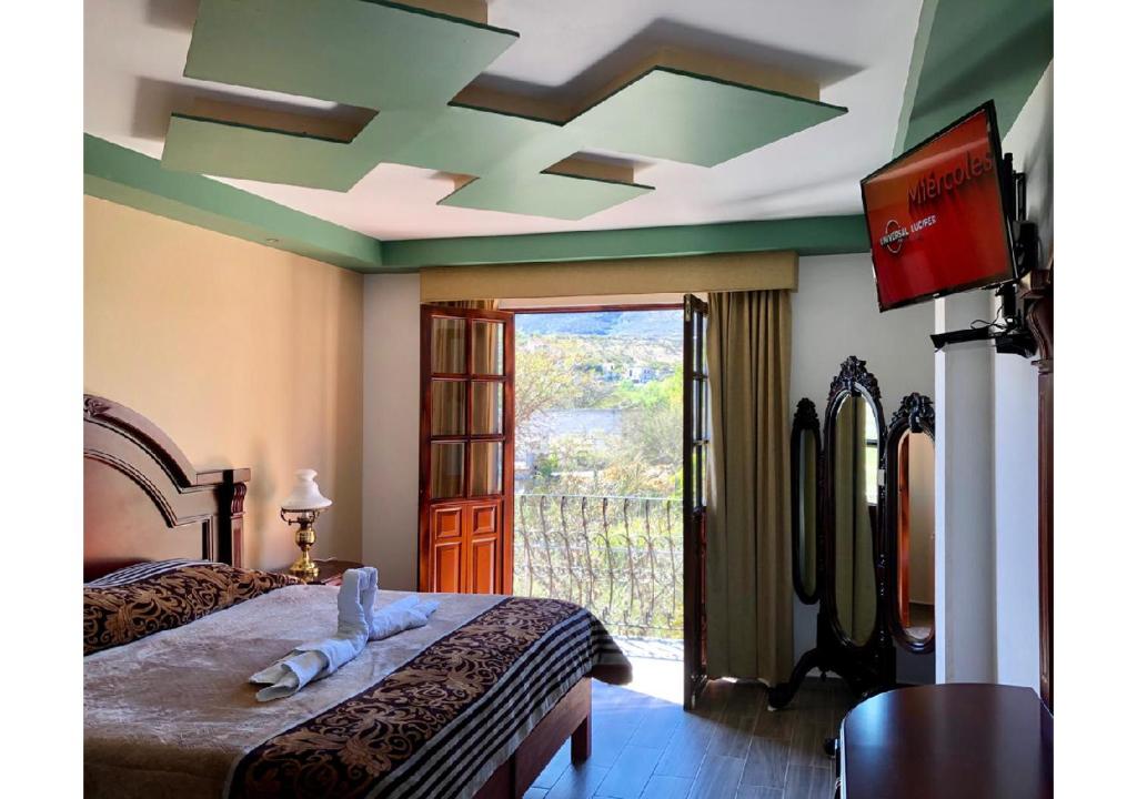 Postel nebo postele na pokoji v ubytování Hotel Hacienda Real