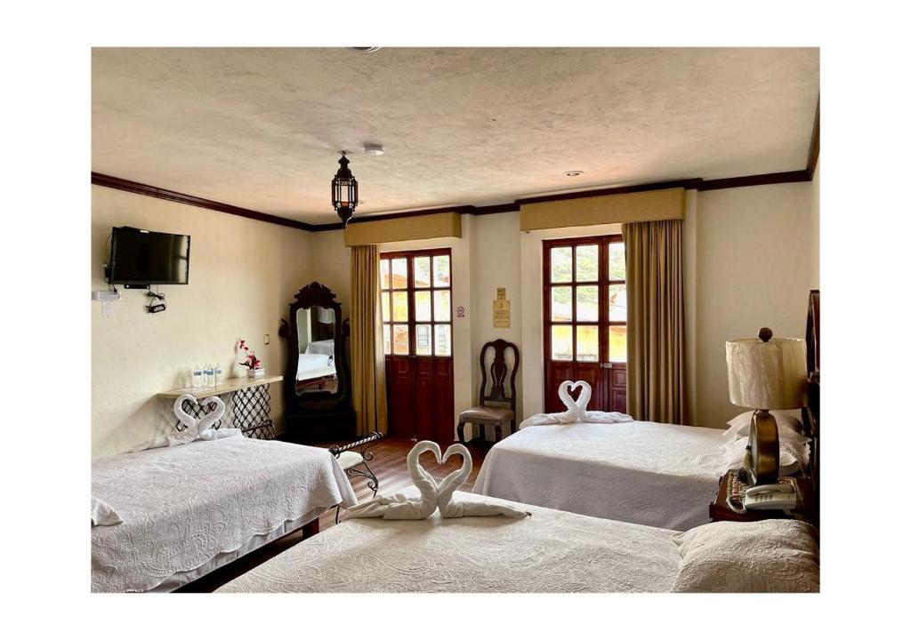 Postel nebo postele na pokoji v ubytování Hotel Hacienda Real