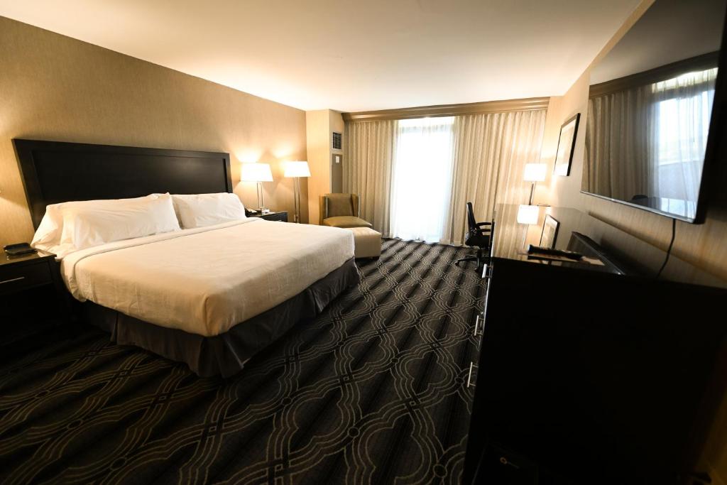 a hotel room with a bed and a television at Grand Resort Hotel - Mt Laurel - Philadelphia in Mount Laurel