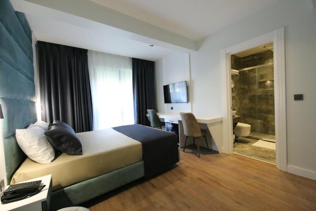Postel nebo postele na pokoji v ubytování AXU AIRPORT HOTEL