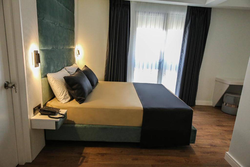 Postel nebo postele na pokoji v ubytování AXU AIRPORT HOTEL