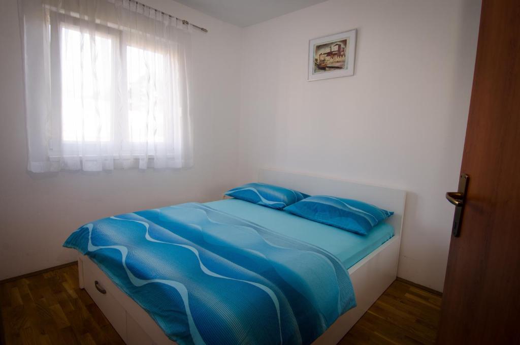 Posteľ alebo postele v izbe v ubytovaní Apartments and Rooms Mišić