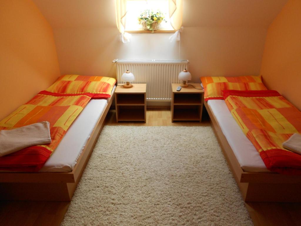 A bed or beds in a room at Penzion Rosnicka Liesek