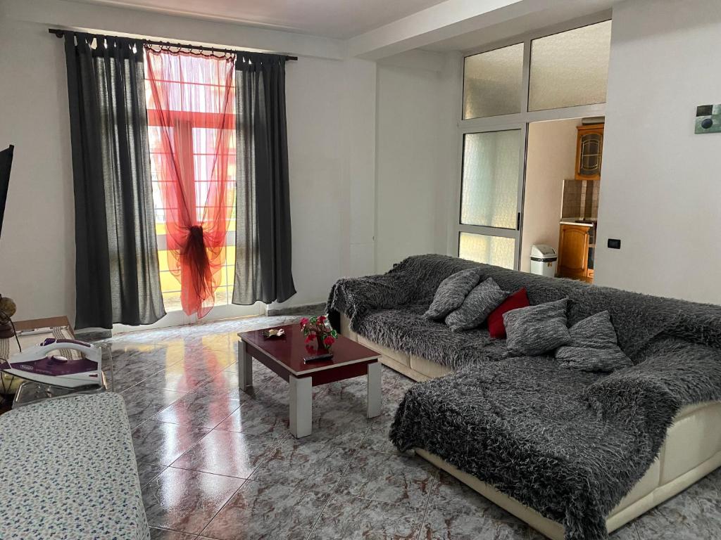 a living room with a couch and a table at Tirana Apartment in Tirana
