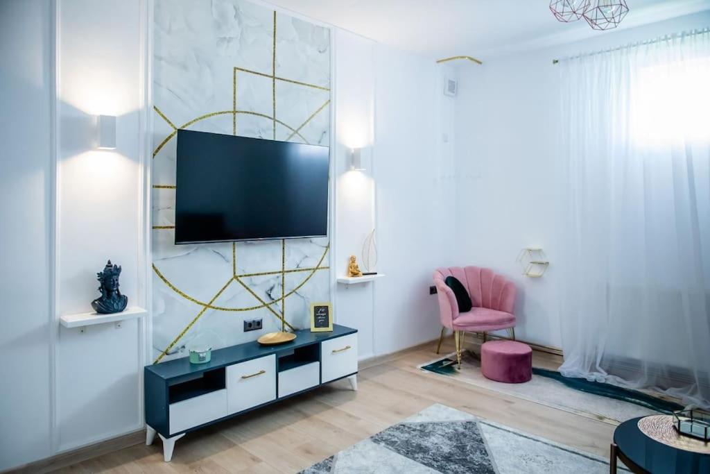 a living room with a tv on a wall at Casa Habitat in Timişoara