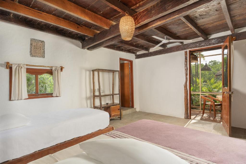 Postel nebo postele na pokoji v ubytování Yaxchen Tulum Cabañas & Cenote