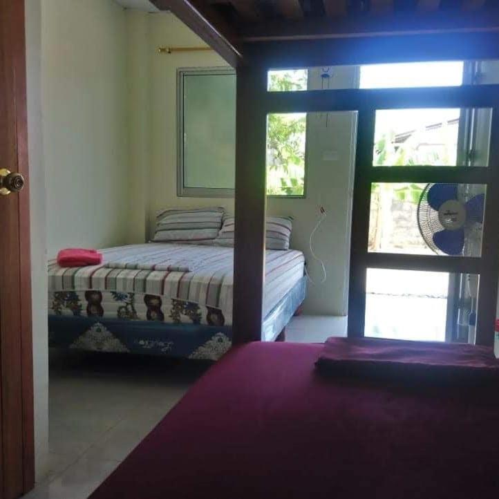 Postel nebo postele na pokoji v ubytování OCEANSURF hosteria