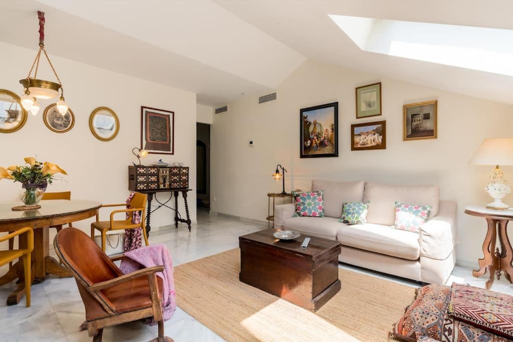 salon z kanapą i stołem w obiekcie Apartamentos RG, San Vicente 22 w Sewilli