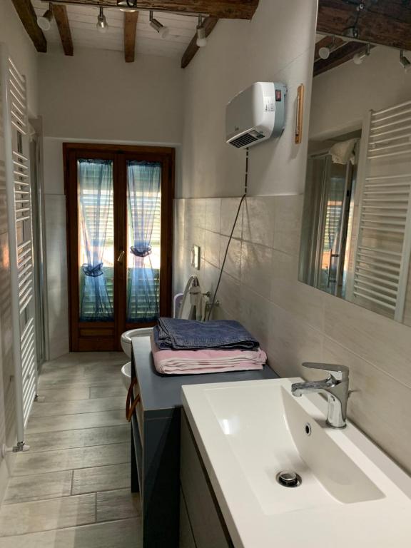 a bathroom with a sink and a mirror at Confortevole casa di montagna- La Campana in San Marcello Pistoiese