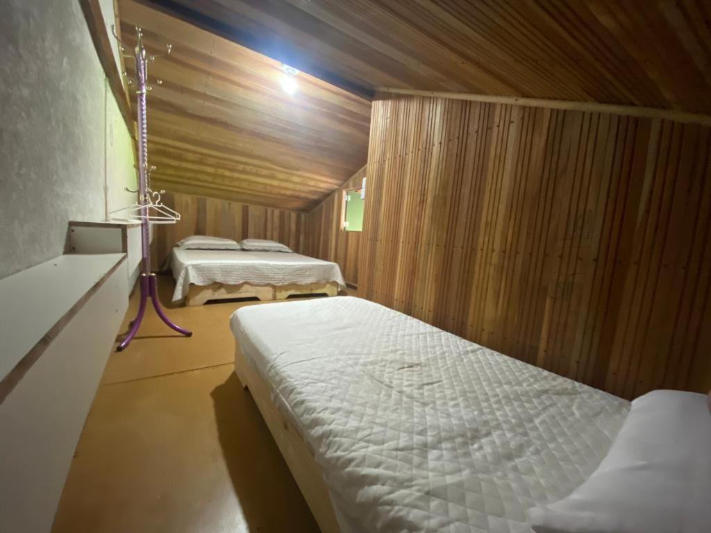 a bedroom with two beds in a room at Hostel Raizer in Campo Grande