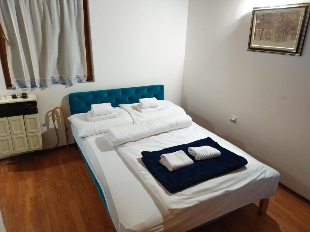 a bedroom with a bed with two towels on it at Florida Resort in Bačka Palanka