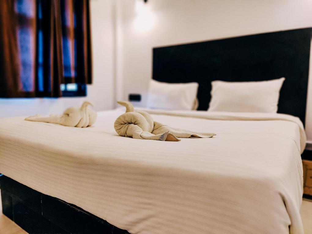 Un pat sau paturi într-o cameră la Hotel Vaggi's Place