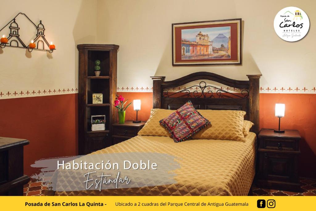 a bedroom with a bed and two lamps and a picture at Posada de San Carlos La Quinta in Antigua Guatemala