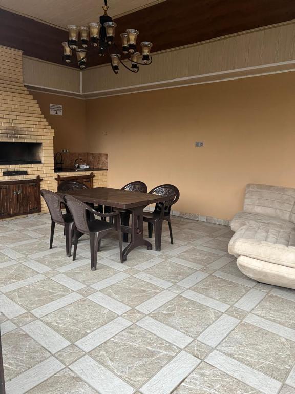 een eetkamer met een tafel en stoelen en een bank bij Villa Qusar in Qusar
