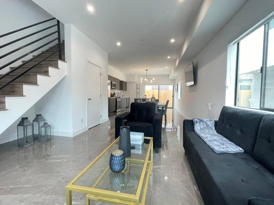 a living room with a couch and a table at Delightful Town Home close to DTLA in Los Angeles