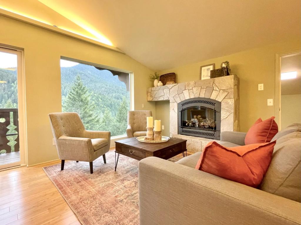 a living room with a couch and a fireplace at Terra Vista Chalet in Port Angeles