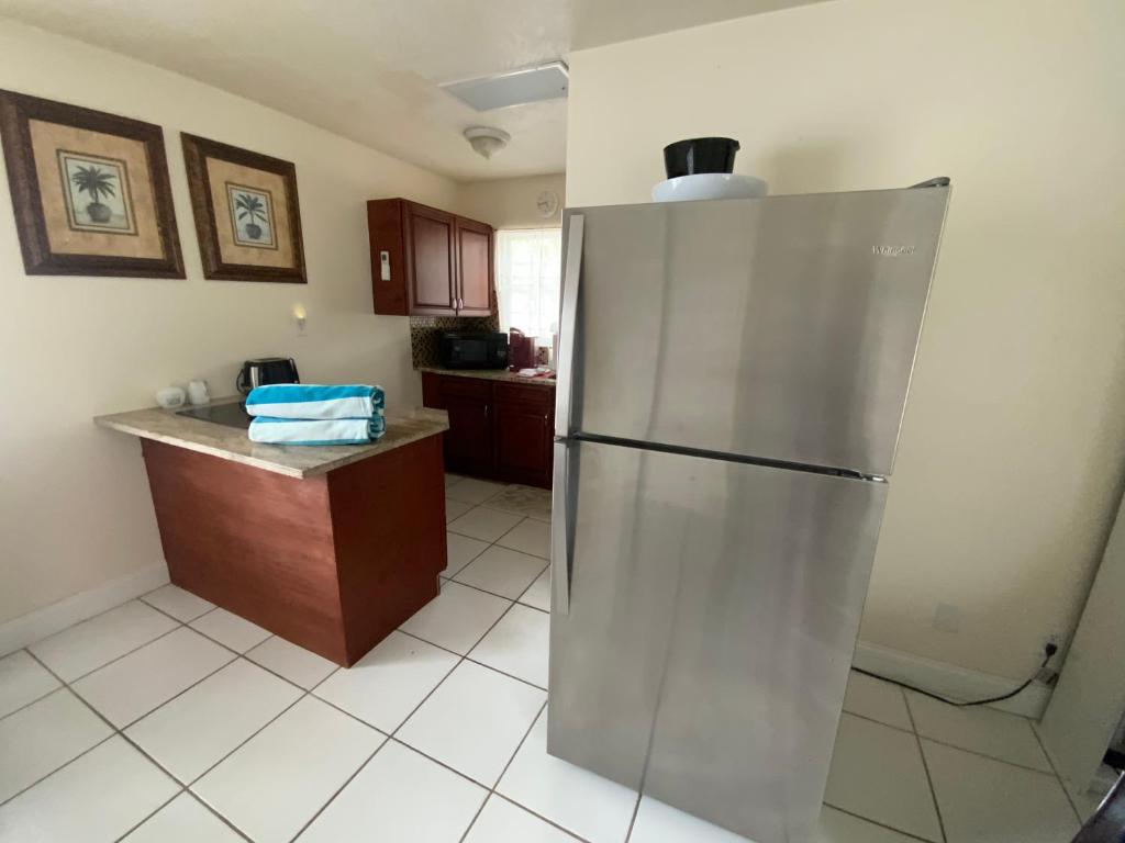 a kitchen with a stainless steel refrigerator and a counter at Lido Sunshine L, Steps to Lido Beach in Sarasota