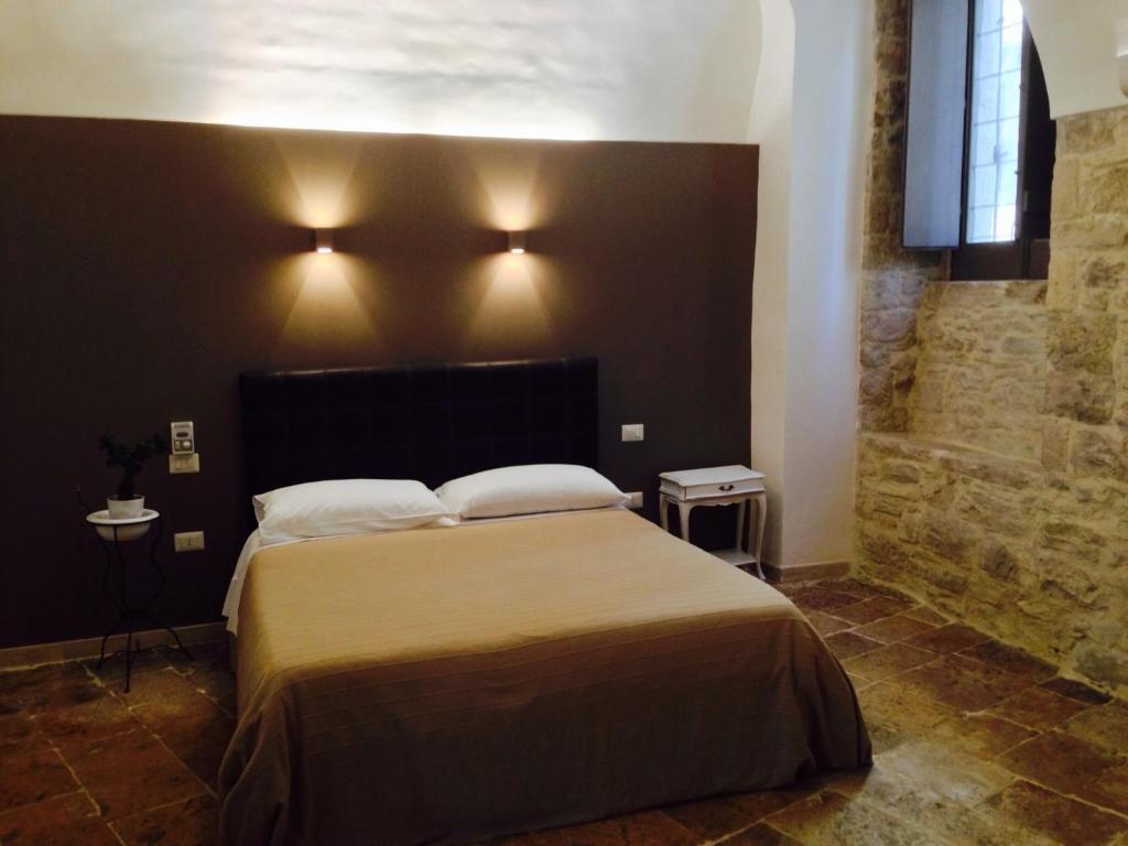 a bedroom with a large bed with two pillows at Pikaret Bed&Breakfast in Corato