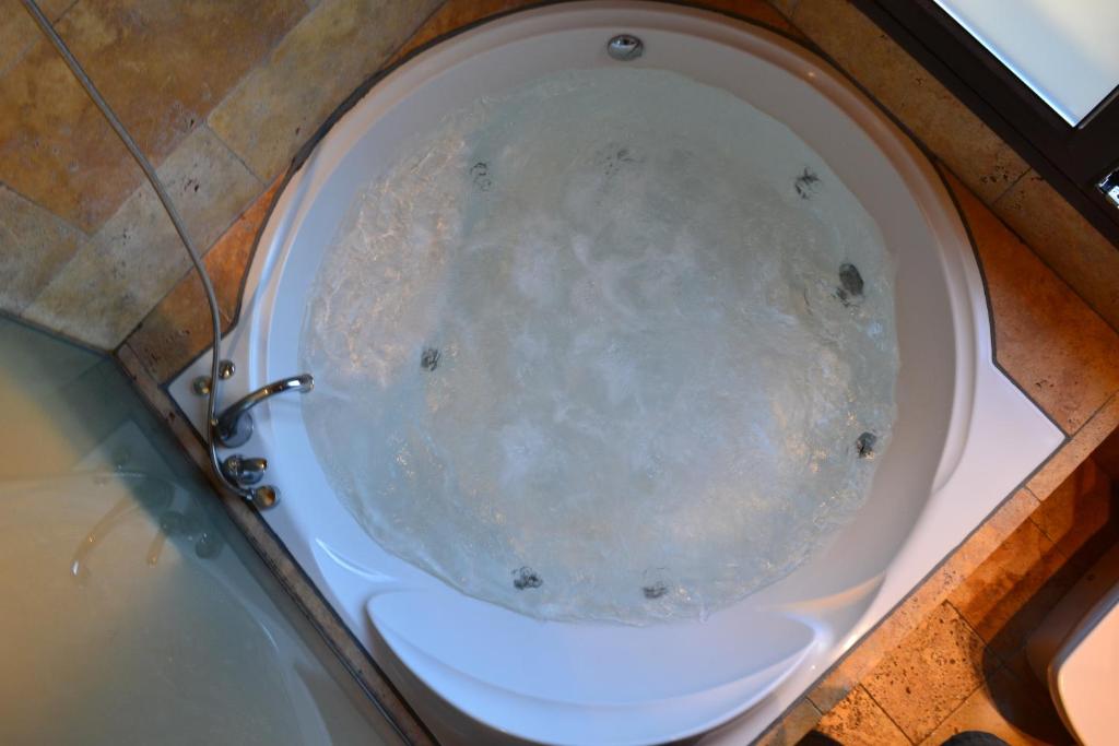 a white toilet in a bathroom with a tub at Ca la Trini Picotxa in Montblanc