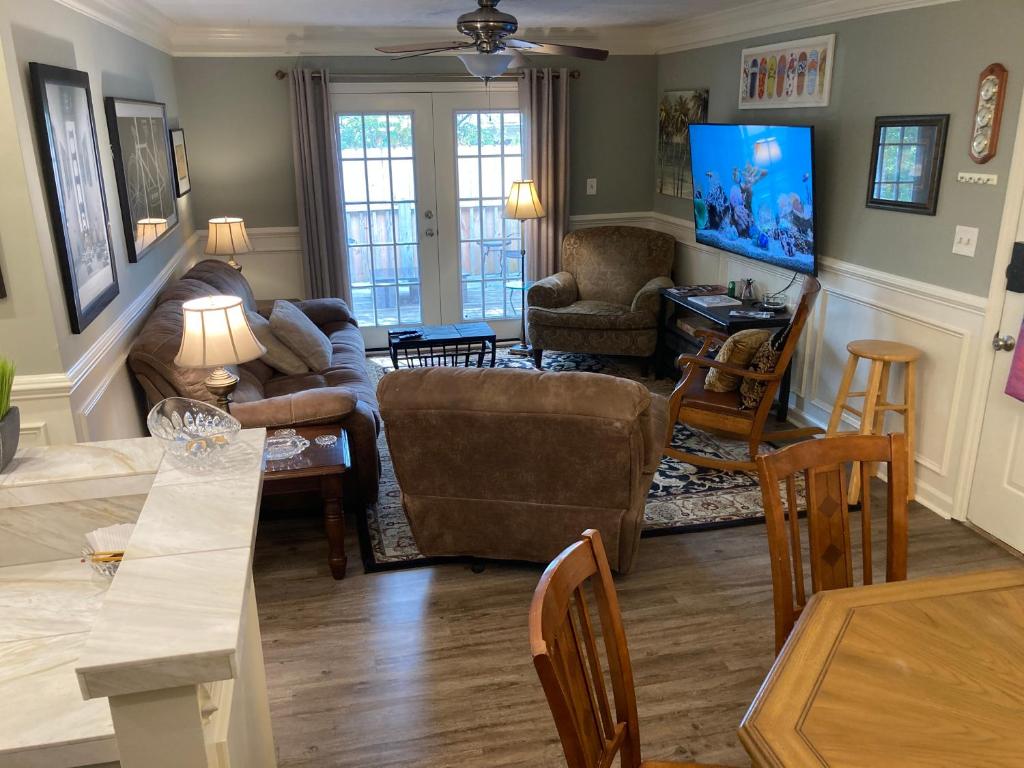 a living room with a couch and a table at Classic City 3 bedroom 2 bath condo with deck close to UGA, Five Points, and Memorial Park in Athens in Athens