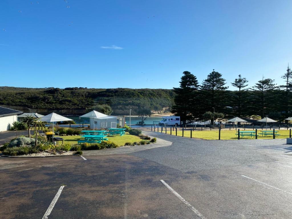 a parking lot with a view of a beach at Southern Ocean Motor Inn in Port Campbell
