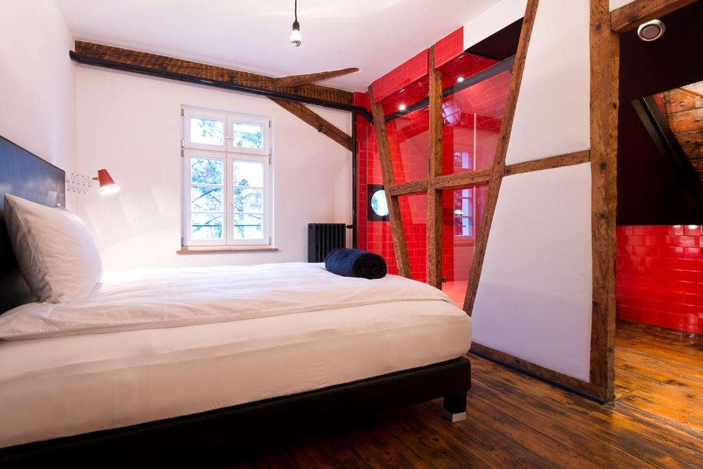a bedroom with a large white bed and red walls at Haus Zauberflöte in Offenburg