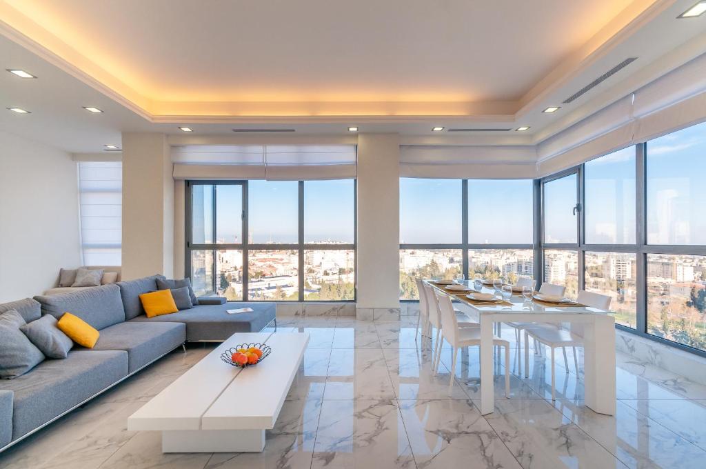 a living room with a couch and a table at Apartment Magical View in Jerusalem