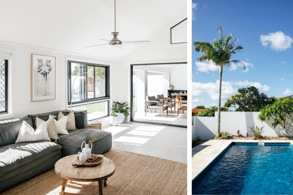 a living room with a couch and a pool at Mysa Yamba - oceanstays in Yamba