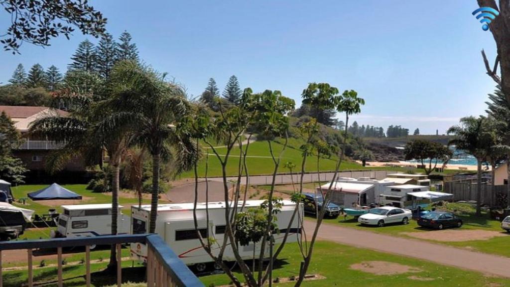 a group of rvs parked in a parking lot at Beachside Getaway in Kiama