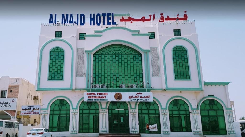 un edificio con un cartel en la parte delantera en ALMajd Hotel en ‘Ibrī