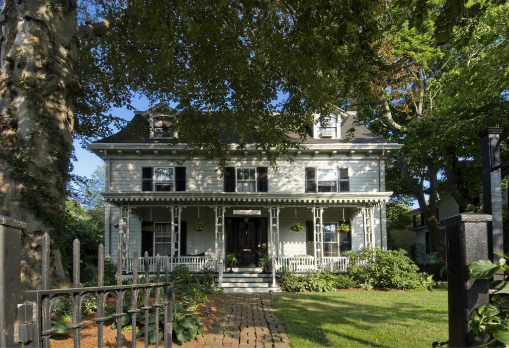 an old white house with a fence in front of it at Marshall Slocum Inn in Newport