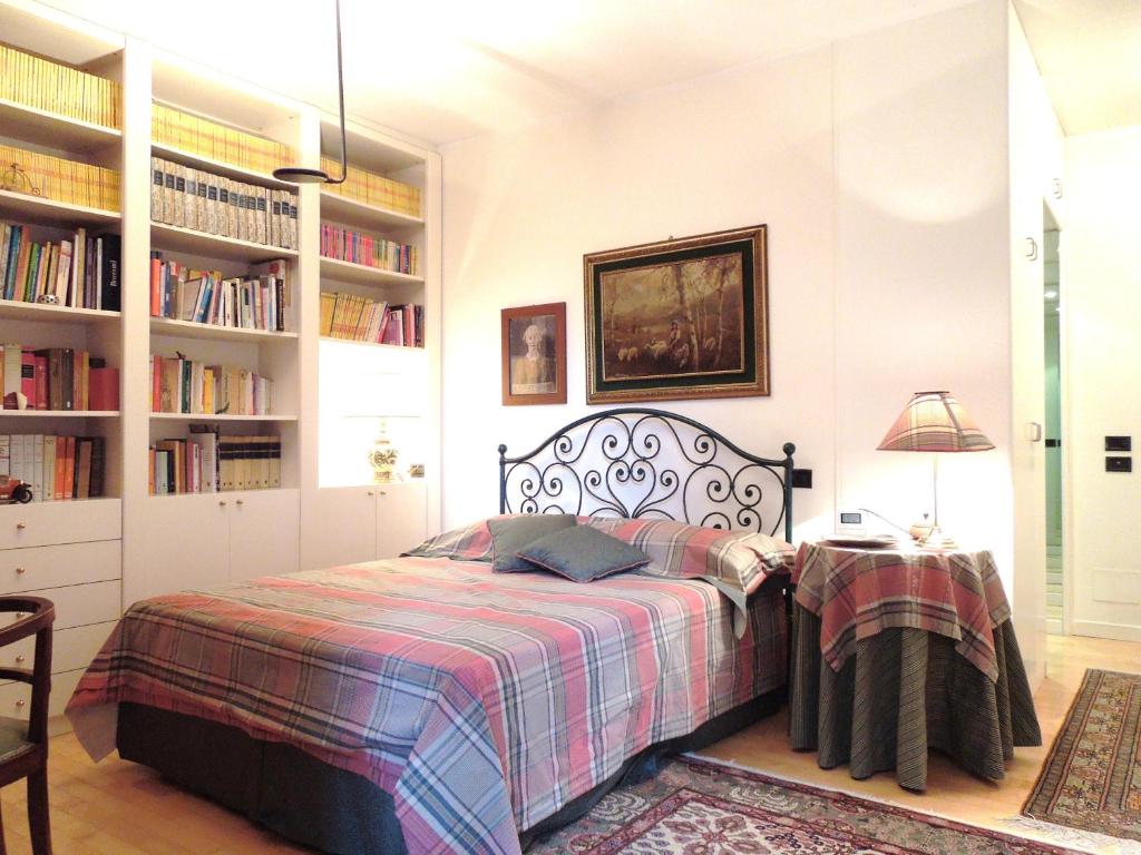a bedroom with a bed and bookshelves at Villa Olivia in Bergamo
