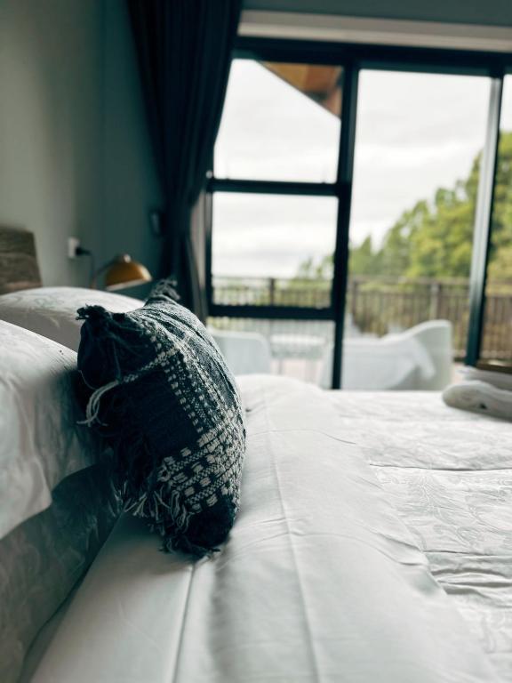 a black pillow sitting on top of a bed at Echo Lodge in Auckland