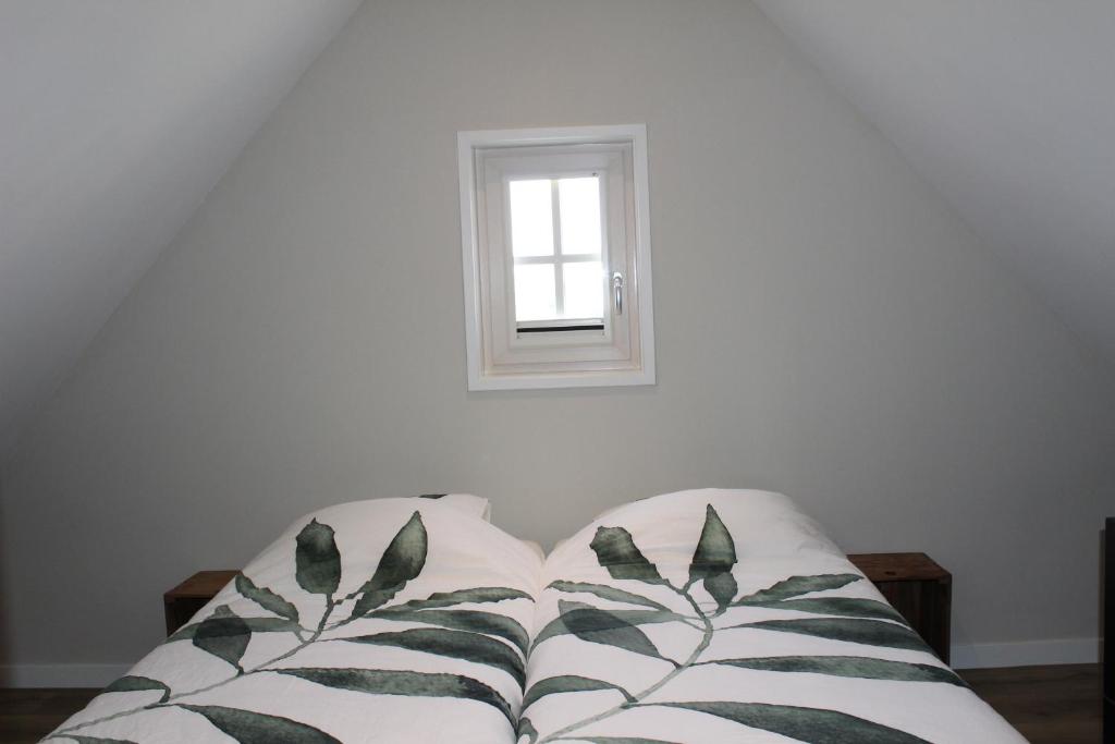 a white couch in a room with a window at Grindweg 4C in Westkapelle