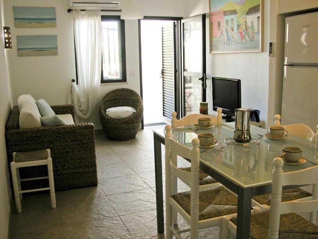 una cucina e un soggiorno con tavolo e divano di Almargem Villa 77 a Cabanas de Tavira