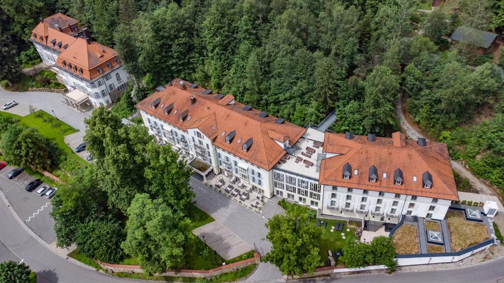 an aerial view of a large building with a red roof at Robenstein Aktivhotel & SPA in Zwiesel