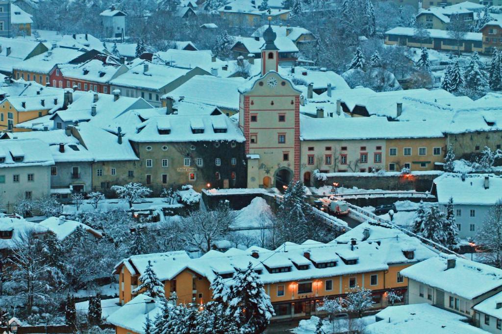 a town covered in snow with buildings at Hotel Restaurant Platzer in Gmünd in Kärnten