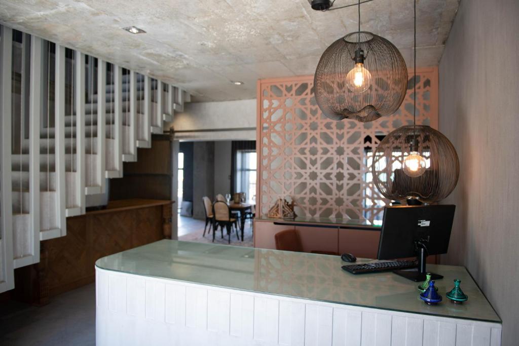 a office with a desk with a laptop on a counter at Belle Maroc Boutique Hotel in Bloubergstrand