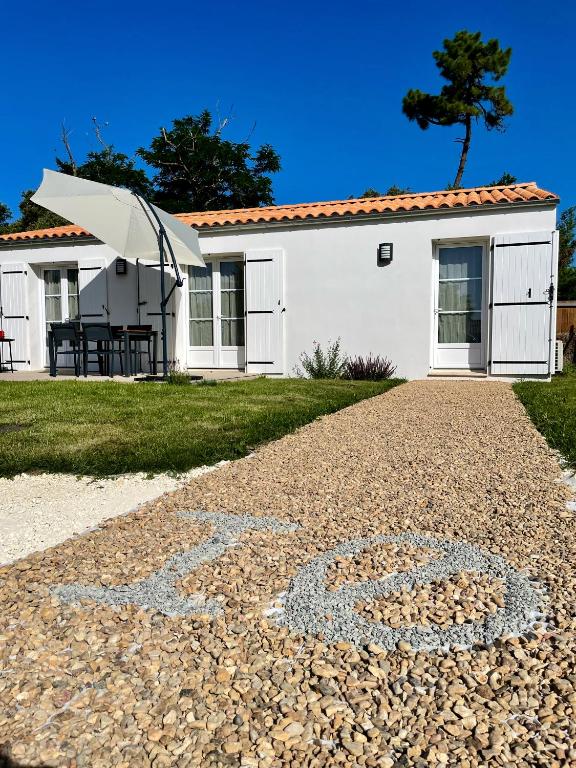 une maison avec une allée de gravier devant elle dans l'établissement Maison neuve au calme idéale pour 4 voyageurs, à Les Sables Vignier