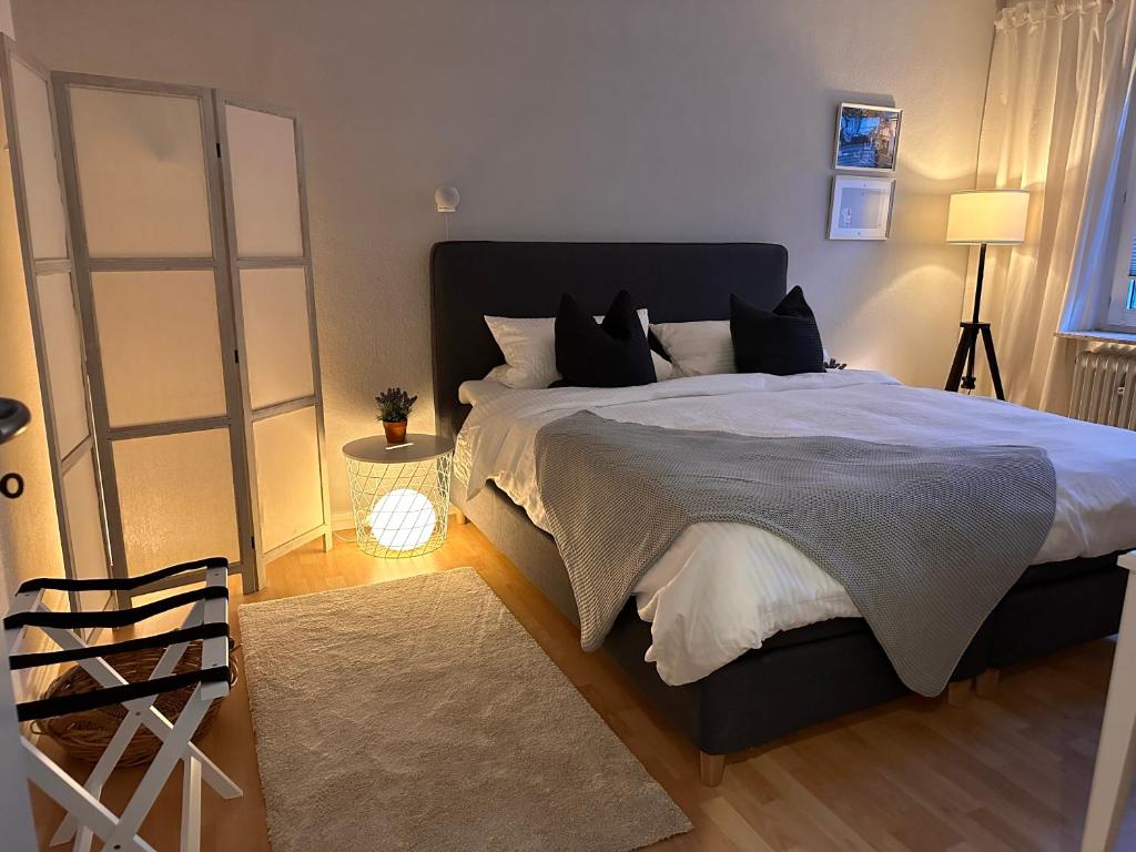 a bedroom with a large bed and a mirror at Wohnung in Wuppertal Elberfeld in Wuppertal