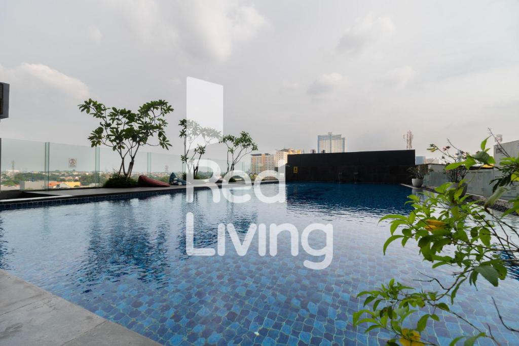 a swimming pool on the roof of a building at RedLiving Apartemen Evenciio - WIN Property Tower 1 in Depok