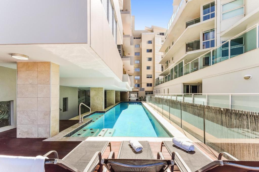 a swimming pool in the middle of a building at Redvue Holiday Apartments in Redcliffe